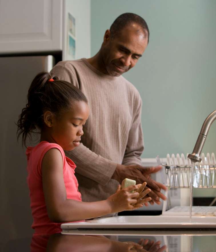 adult and child at a sink