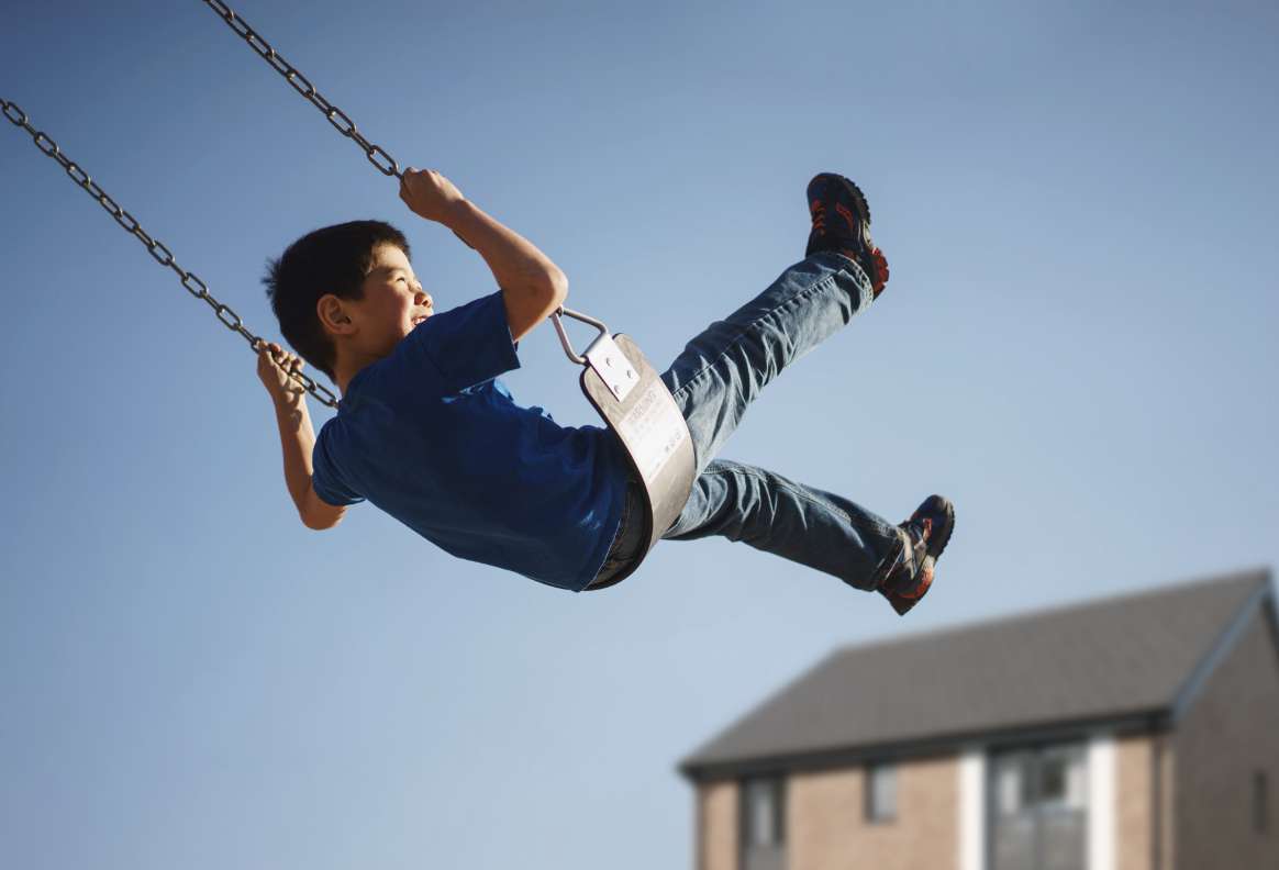 a child playing on a swing